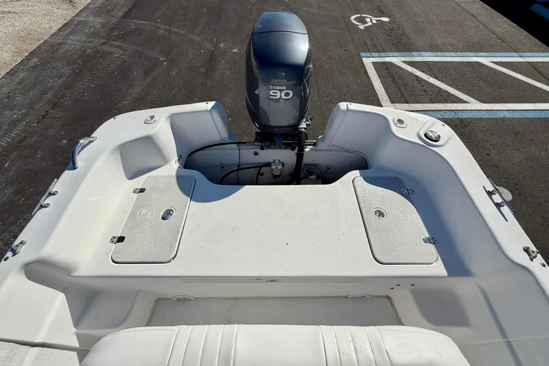 Slide: The Image of 2010 Carolina Skiff 192 DLV boat with Yamaha 90 outboard motor, parked on asphalt. - 20