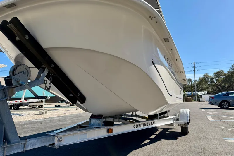 Slide: The Image of 2010 Carolina Skiff 192 DLV boat on trailer in parking lot, sunny day. - 22