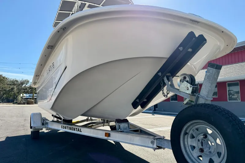 Slide: The Image of 2010 Carolina Skiff 192 DLV boat on trailer, parked outdoors. - 23