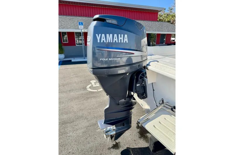 Slide: The Image of 2010 Carolina Skiff 192 DLV with Yamaha four-stroke outboard motor in parking lot. - 26