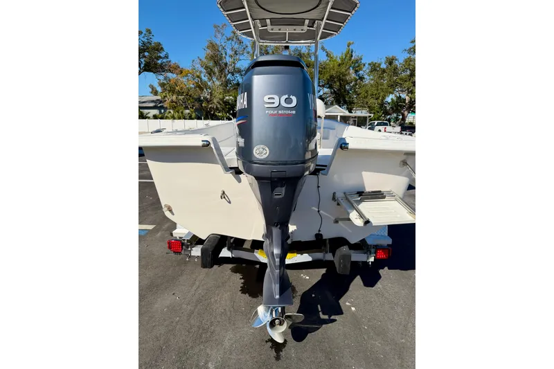 Slide: The Image of 2010 Carolina Skiff 192 DLV with Yamaha 90 horsepower outboard motor, parked outdoors. - 27