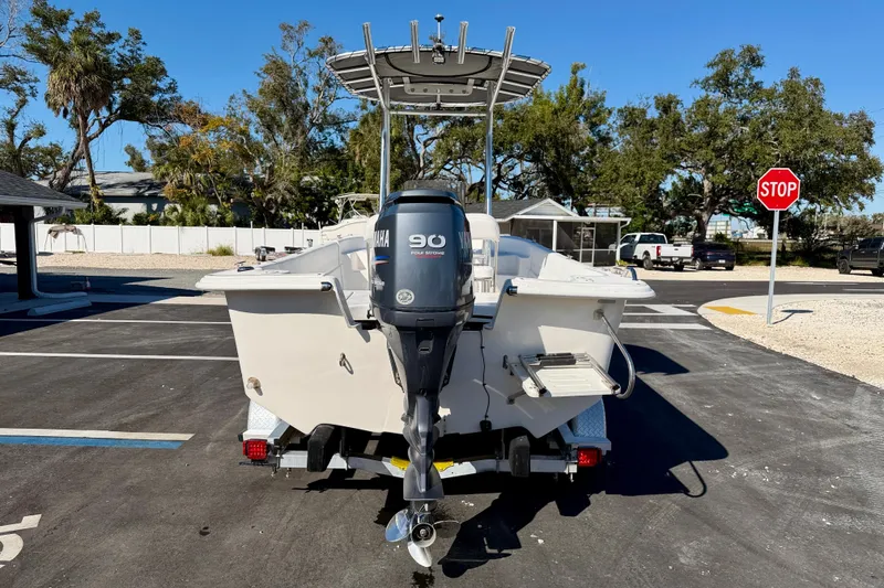 Slide: The Image of 2010 Carolina Skiff 192 DLV boat with Yamaha 90 outboard motor, parked outdoors. - 6