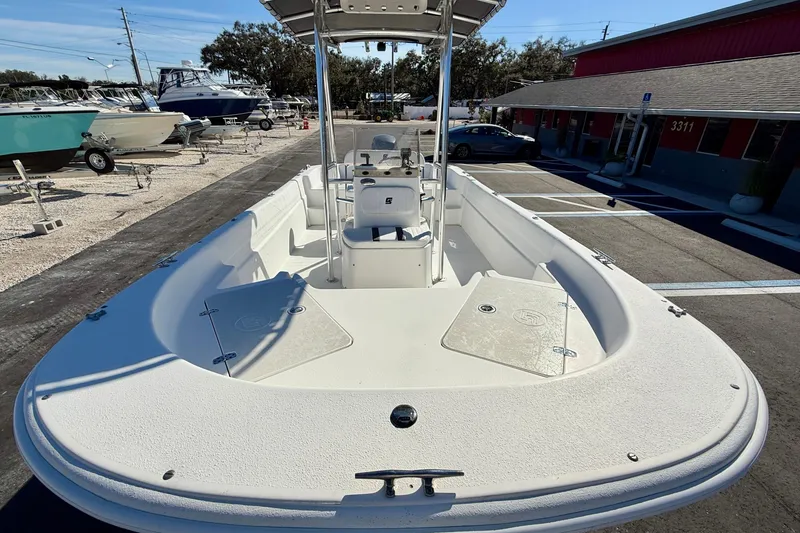 Slide: The Image of 2010 Carolina Skiff 192 DLV boat in a parking lot, showcasing spacious deck. - 8