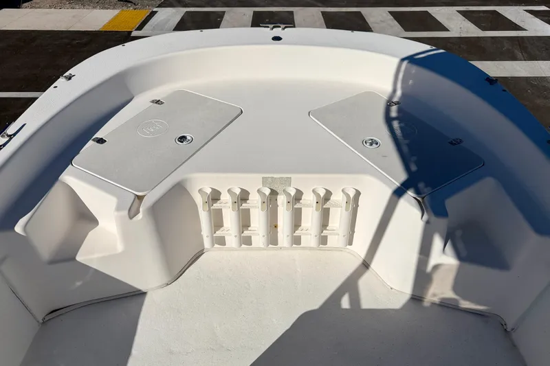 Slide: The Image of 2010 Carolina Skiff 192 DLV boat interior with storage compartments and rod holders. - 9