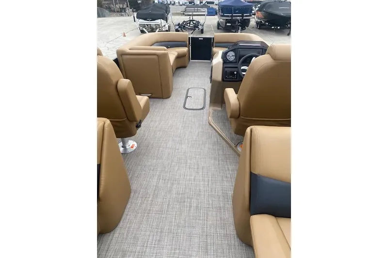 Slide: The Image of 2026 Manitou 25 Encore RF VPII interior with tan seating and modern dashboard. - 13