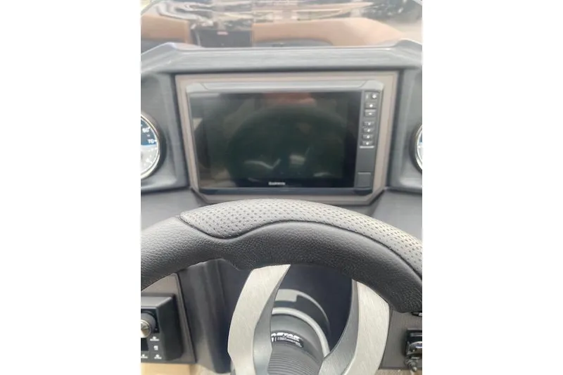 Slide: The Image of Steering wheel and dashboard of 2026 Manitou 25 Encore RF VPII boat. - 16