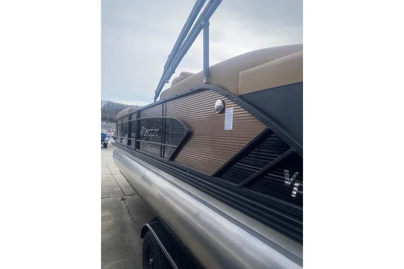 Slide: The Image of 2026 Manitou 25 Encore RF VPII pontoon boat, side view, docked outdoors. - 6