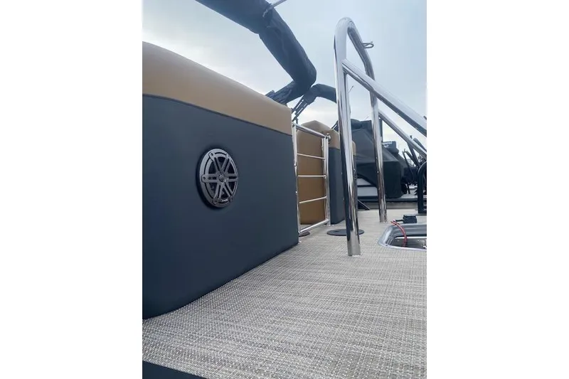 Slide: The Image of 2026 Manitou 25 Encore RF VPII boat interior with speaker and railing details. - 7