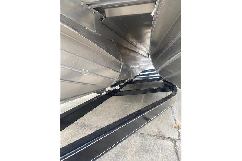 Slide: The Image of Underneath view of 2026 Manitou 25 Encore RF VPII pontoon boat on trailer. - 8