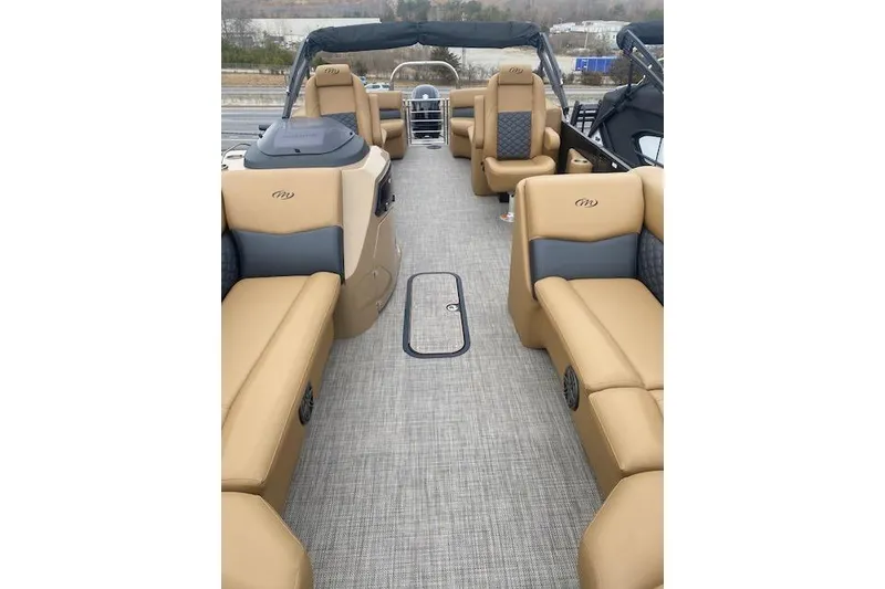 Slide: The Image of 2026 Manitou 25 Encore RF VPII pontoon boat with luxurious tan seating and spacious layout. - 9