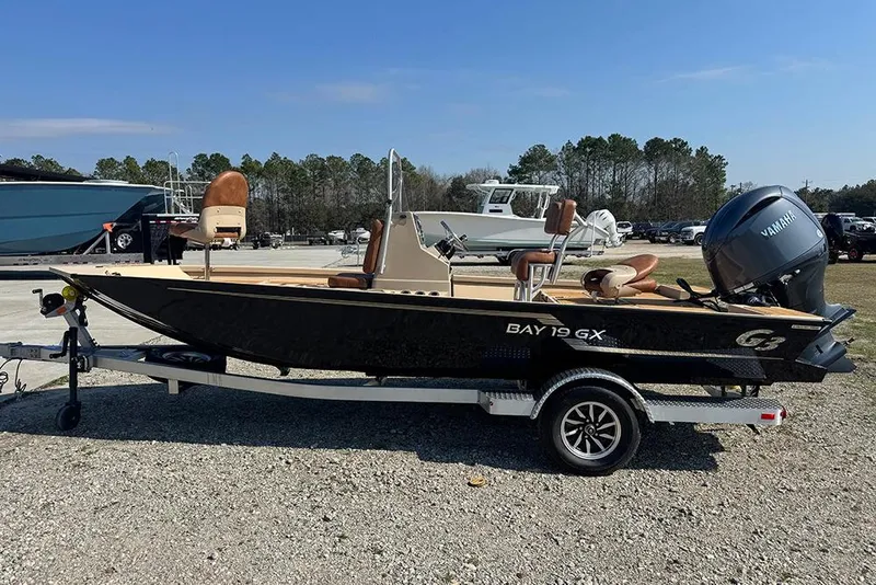 The Image of 2026 G3 Bay 19 GX boat with Yamaha engine on trailer, parked outdoors. - 0