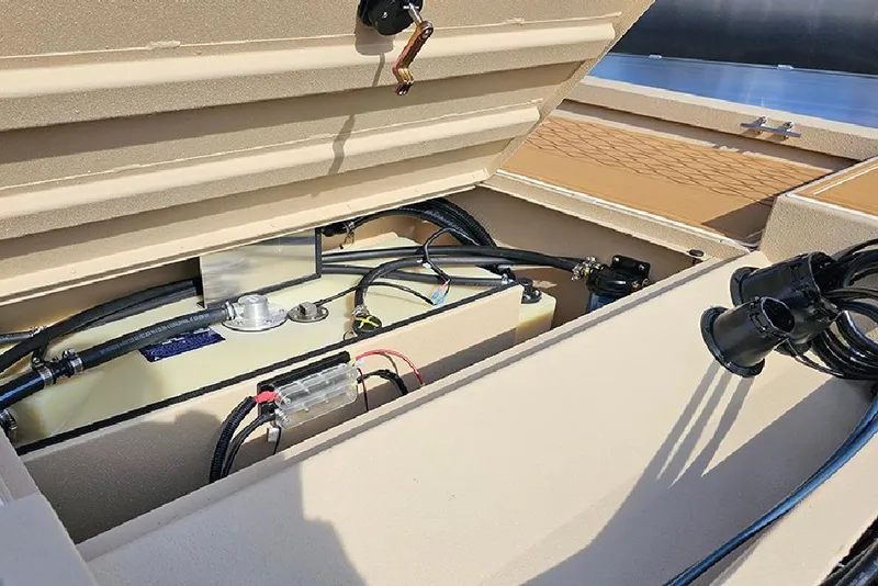 Slide: The Image of Open storage compartment of 2026 G3 Bay 19 GX boat, showing internal components and wiring. - 10