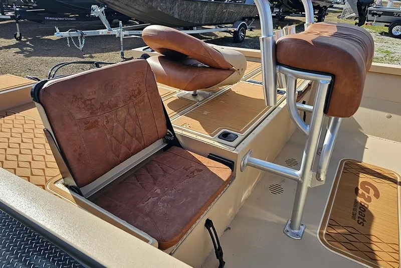 Slide: The Image of 2026 G3 Bay 19 GX boat interior with brown cushioned seats and metal frame. - 11