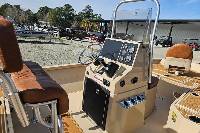 Slide: The Image of 2026 G3 Bay 19 GX boat interior with steering console and brown seating. - 12