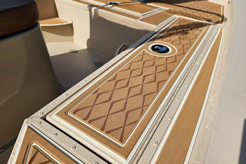 Slide: The Image of 2026 G3 Bay 19 GX boat interior with diamond-patterned deck and sleek design. - 13