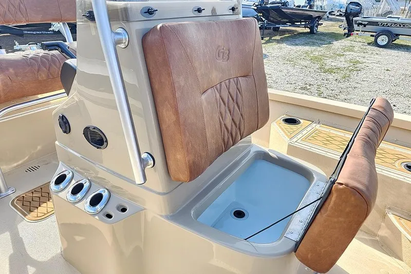 Slide: The Image of 2026 G3 Bay 19 GX boat interior with tan leather seats and storage compartment. - 15