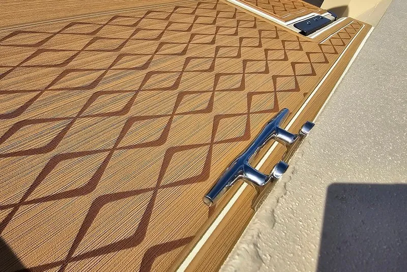 Slide: The Image of 2026 G3 Bay 19 GX boat deck with diamond pattern and chrome cleat. - 17