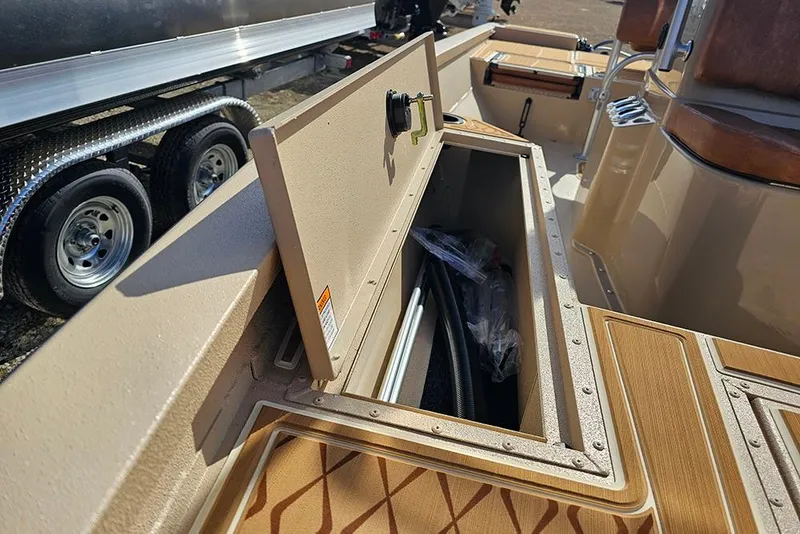 Slide: The Image of 2026 G3 Bay 19 GX boat storage compartment with open lid, showcasing interior space. - 30