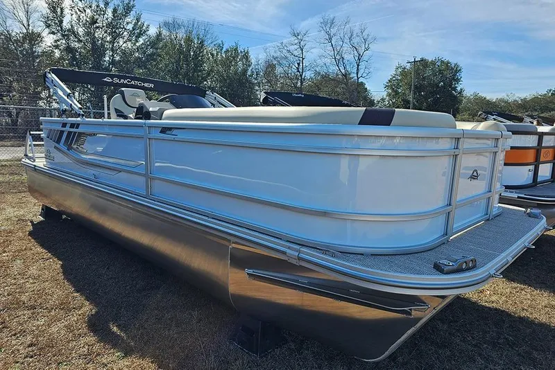 The Image of 2026 SunCatcher Select 22RF pontoon boat displayed outdoors on grass. - 1