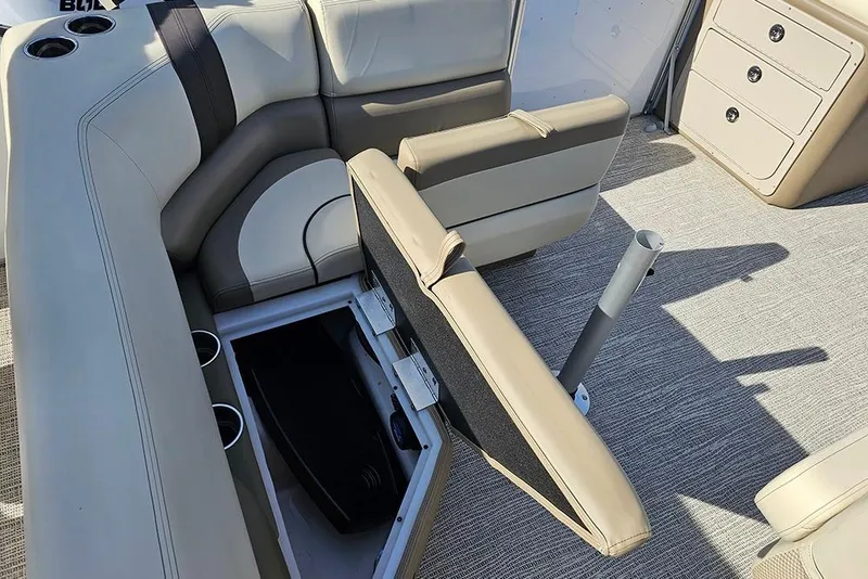 Slide: The Image of 2026 SunCatcher Select 22RF boat interior with beige seating and storage compartment. - 12