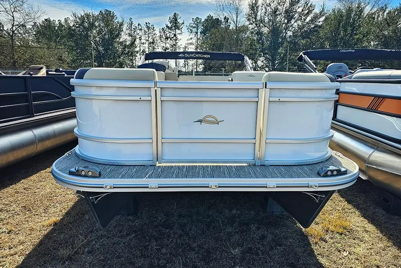 Slide: The Image of 2026 SunCatcher Select 22RF pontoon boat, rear view, parked on grass. - 2