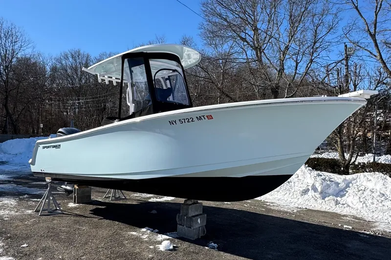 The Image of 2023 Sportsman Open 232 Center Console boat on display in a snowy outdoor setting. - 0