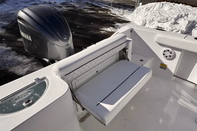 Slide: The Image of 2023 Sportsman Open 232 Center Console boat with Yamaha engine, featuring white seating and snow background. - 12