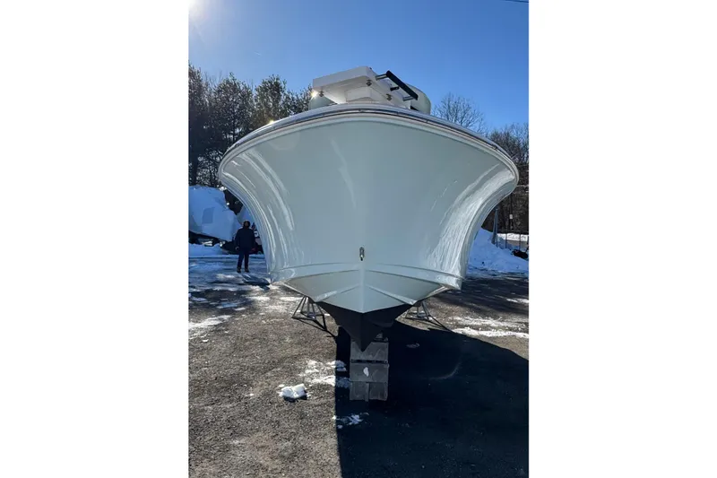 Slide: The Image of 2023 Sportsman Open 232 Center Console boat on display in a snowy outdoor setting. - 3