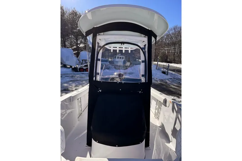 Slide: The Image of 2023 Sportsman Open 232 Center Console boat with protective cover, parked outdoors in winter. - 6