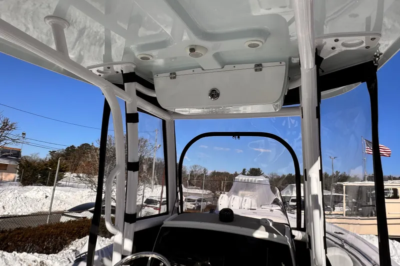 Slide: The Image of 2023 Sportsman Open 232 Center Console boat interior with clear skies and snow in the background. - 7