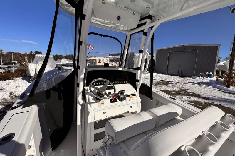 Slide: The Image of 2023 Sportsman Open 232 Center Console boat interior with steering wheel and seating. - 8
