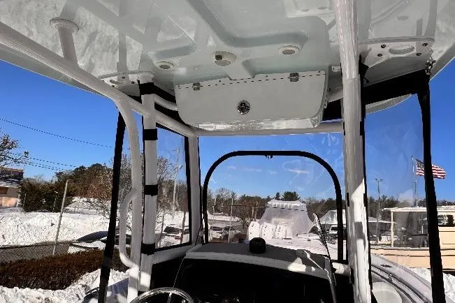 Slide: The Image of 2023 Sportsman Open 232 Center Console boat interior with clear canopy and snowy background. - 9