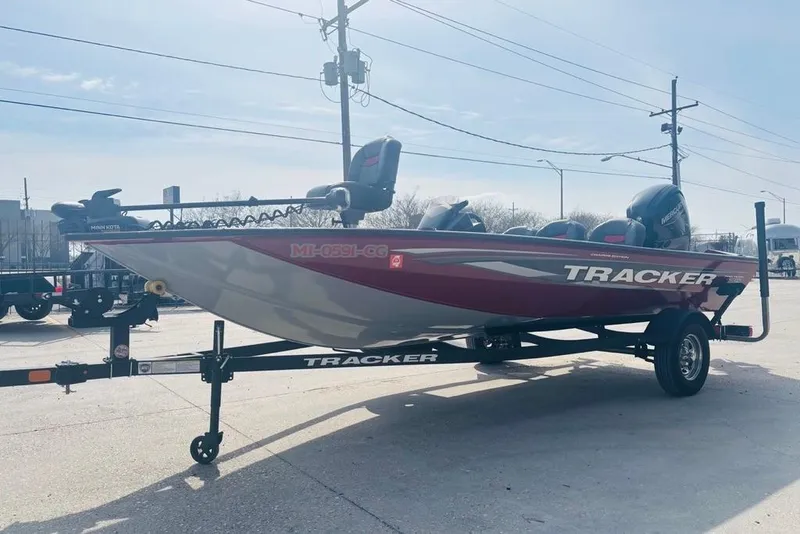 Slide: The Image of 2025 Tracker Pro Team 175 Crappie Edition boat on trailer, parked outdoors. - 11