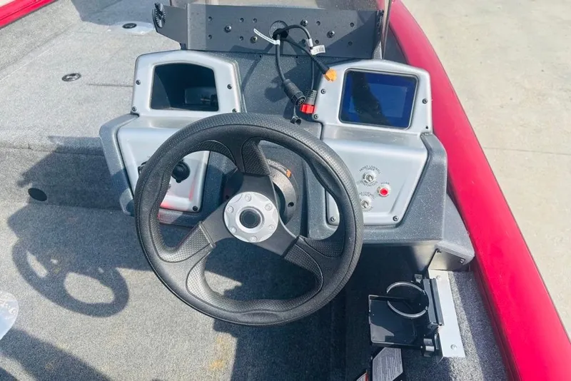 Slide: The Image of 2025 Tracker Pro Team 175 Crappie Edition boat dashboard with steering wheel and controls. - 15