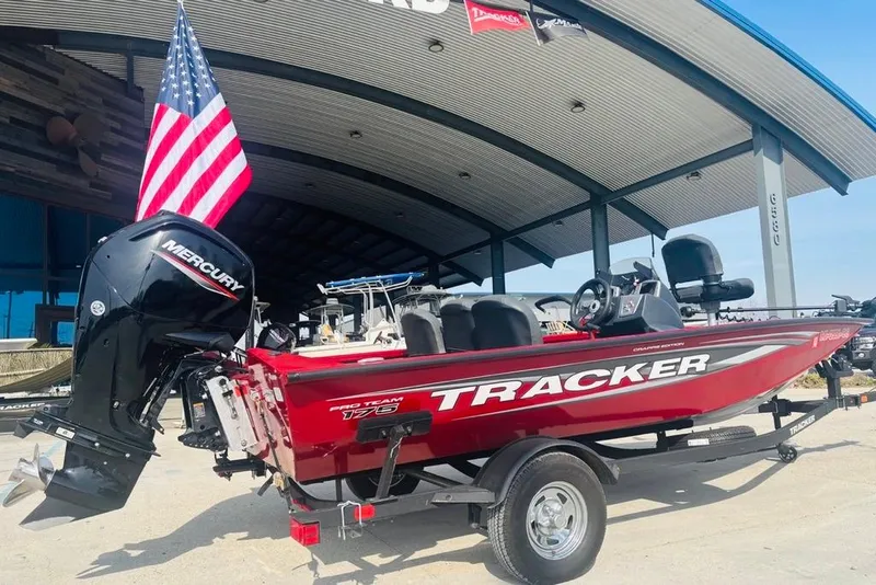 Slide: The Image of 2025 Tracker Pro Team 175 Crappie Edition boat with Mercury engine, displayed outdoors. - 4