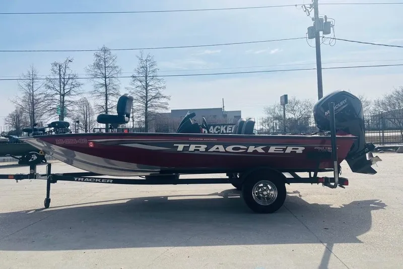 Slide: The Image of 2025 Tracker Pro Team 175 Crappie Edition boat on trailer, parked outdoors. - 9