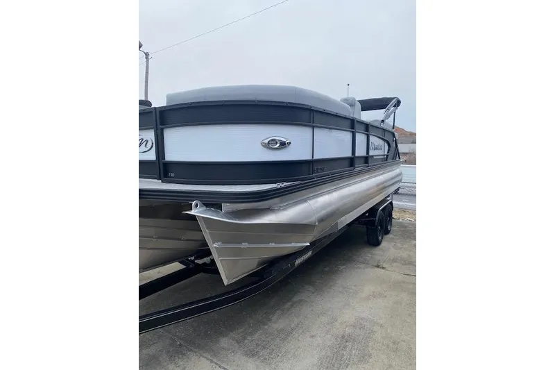 The Image of 2026 Manitou 23 Encore RF SHP pontoon boat on trailer, side view. - 1