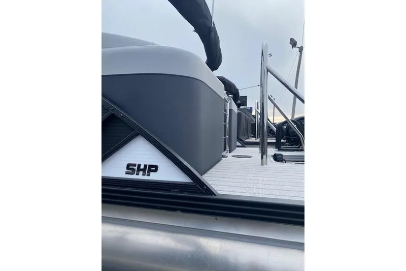 Slide: The Image of 2026 Manitou 23 Encore RF SHP pontoon boat, sleek design, side view. - 5