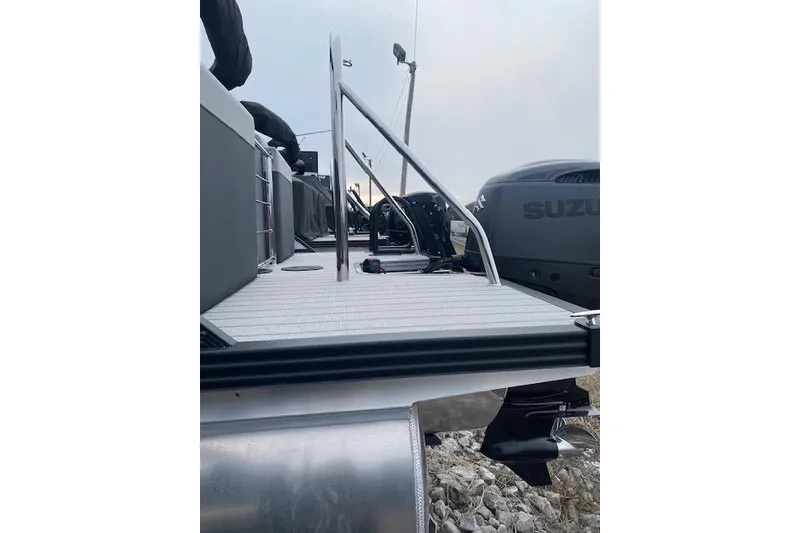 Slide: The Image of 2026 Manitou 23 Encore RF SHP pontoon boat with Suzuki outboard motor. - 6