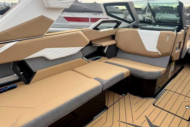 Slide: The Image of 2026 MasterCraft X24 boat interior with tan and gray seating, modern design. - 14