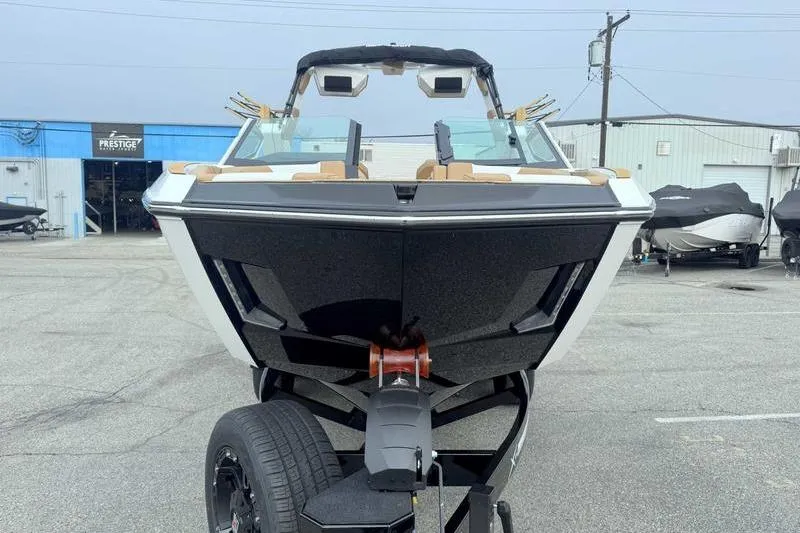 Slide: The Image of 2026 MasterCraft X24 boat on trailer in a parking lot. - 6