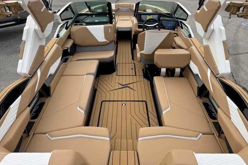 Slide: The Image of 2026 MasterCraft X24 boat interior with luxurious tan seating and modern dashboard. - 9