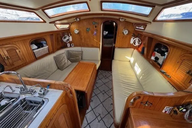Slide: The Image of Interior of 1986 Fairweather Mariner 39 sailboat with cozy seating and wooden finishes. - 12