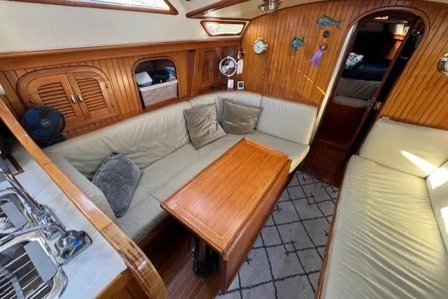 Slide: The Image of Cozy interior of 1986 Fairweather Mariner 39 sailboat with wooden accents and seating area. - 14