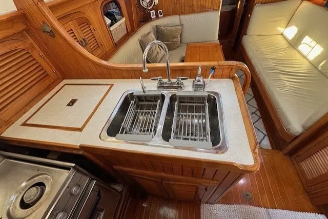Slide: The Image of 1986 Fairweather Mariner 39 yacht interior with dual sinks and wooden cabinetry. - 16