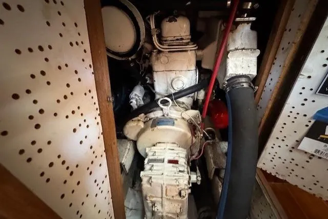 Slide: The Image of Engine compartment of a 1986 Fairweather Mariner 39 boat, featuring mechanical components. - 18