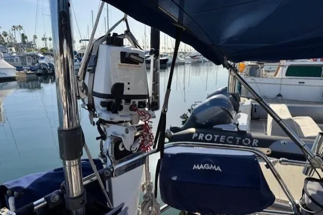 Slide: The Image of 1986 Fairweather Mariner 39 sailboat docked in marina with equipment and calm water. - 25