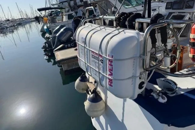 Slide: The Image of 1986 Fairweather Mariner 39 with life raft and fenders docked at marina. - 28