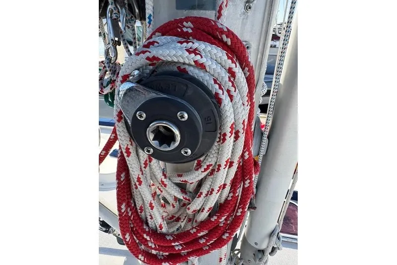 Slide: The Image of Red and white rope coiled on a 1986 Fairweather Mariner 39 sailboat mast. - 32