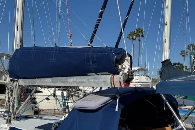 Slide: The Image of 1986 Fairweather Mariner 39 sailboat with blue sail cover and rigging, docked in marina. - 35